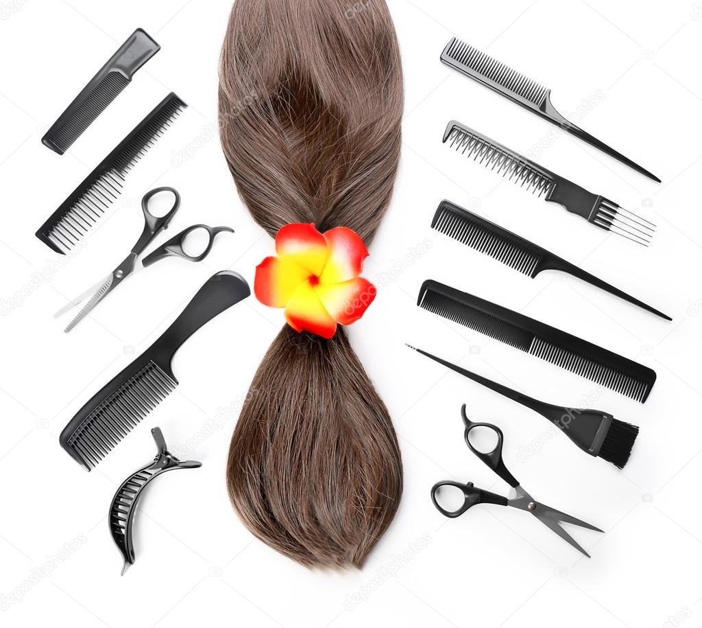 Barber set with strand of hair and tools, isolated on white