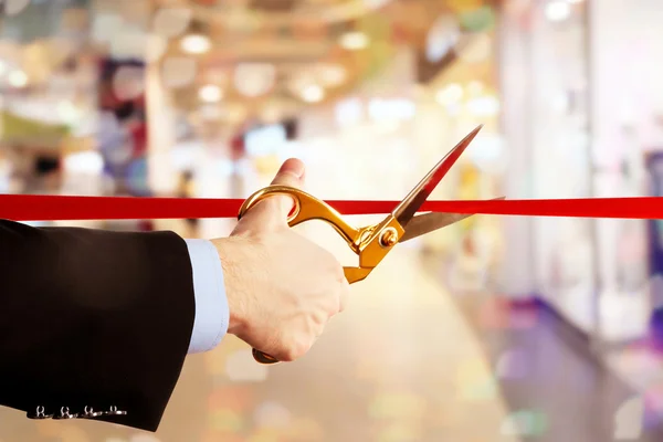 Businessman cutting red ribbon — Stock Photo, Image