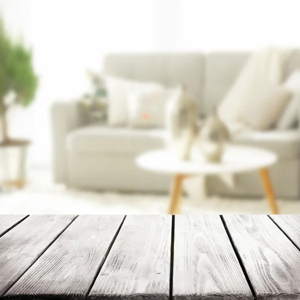 Empty wooden table and blurred interior — Stock Photo, Image