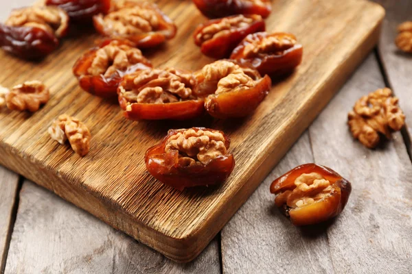 Walnut, date fruit on wooden table, close-up — Stock Photo, Image