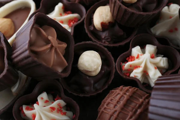 Lahodné čokoládové bonbony pozadí, zblízka — Stock fotografie