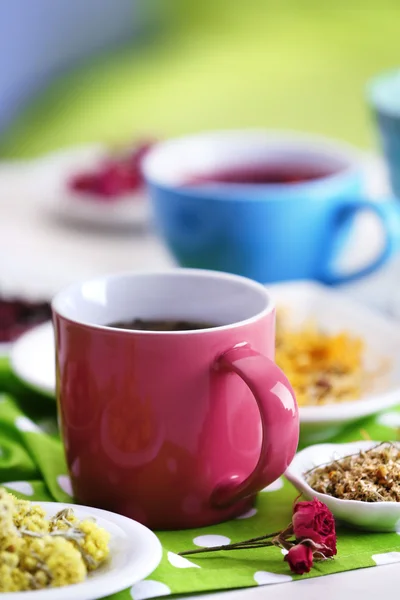 Cup of tea with aromatic dry tea on wooden background — Stock Photo, Image