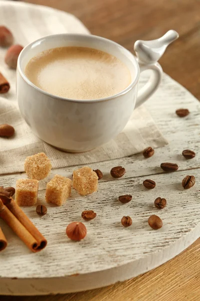 Cup of coffee with sugar and cinnamon on white wooden mat — Stock Photo, Image