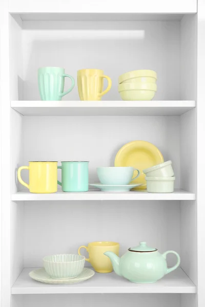Dishes in cupboard in kitchen — Stock Photo, Image
