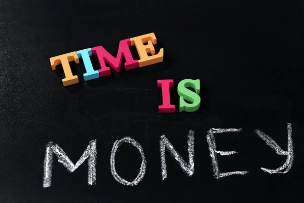 Time is money concept on a blackboard background — Stock Photo, Image