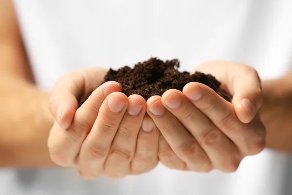 Male hands holding soil — Stock Photo, Image