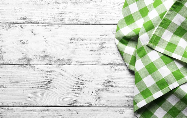Checkered napkin on wooden background — Stock Photo, Image