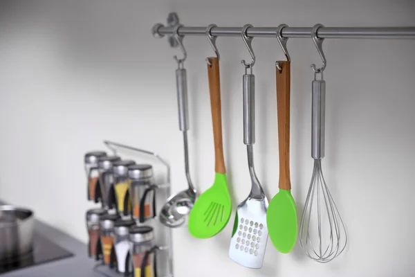 Set of cutlery hanging on wall in the kitchen — Stock Photo, Image