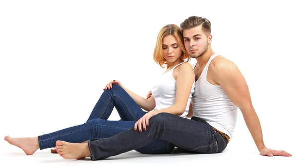 Ungt par i kärlek sitter tillsammans, isolerade på vit — Stockfoto