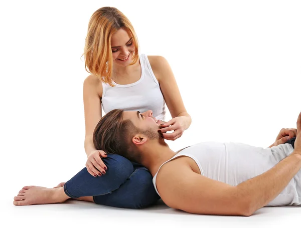 Young man putting his head on the girlfriend's laps, isolated on white — Stock Photo, Image