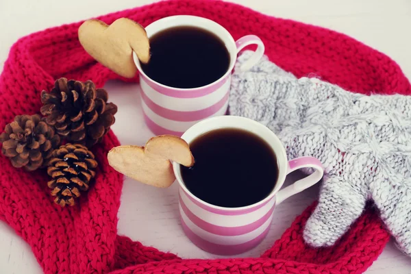 Heart shape cookie on cup of coffee with red knitted scarf closeup — Stock Photo, Image