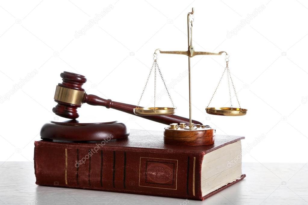 Wooden gavel with justice scales and book on white background