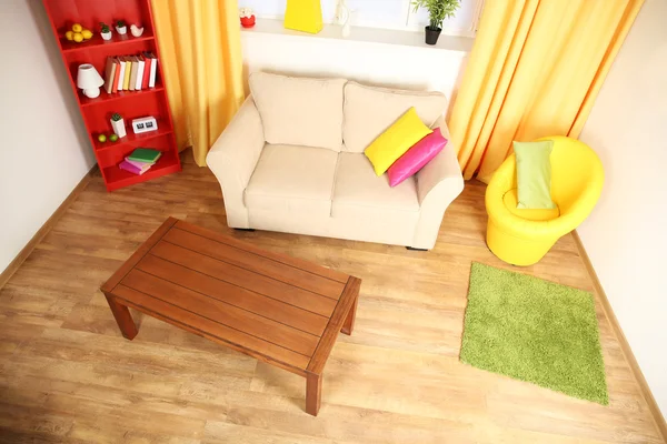 Modern living room interior with beige  sofa, wooden coffee table and yellow chair — Stock Photo, Image