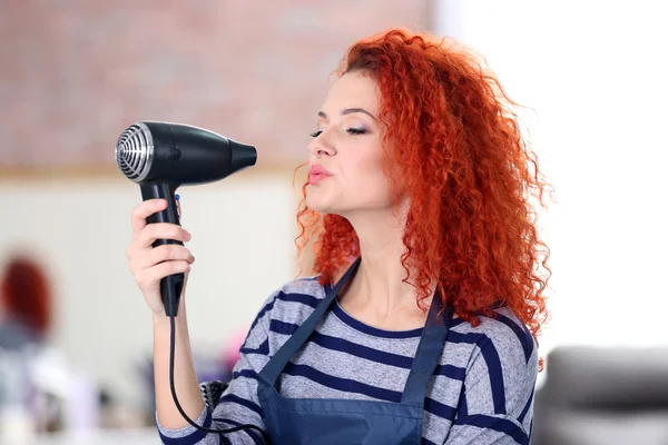 Professional hairdresser with hairdryer — Stock Photo, Image