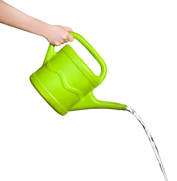 Mão feminina derramando água de regador de plástico verde pode, isolado em branco — Fotografia de Stock