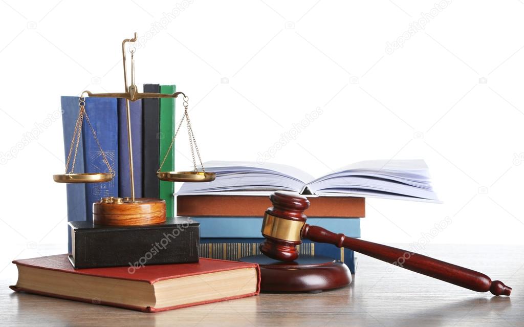 Wooden gavel with justice scales and stacks of books on white background