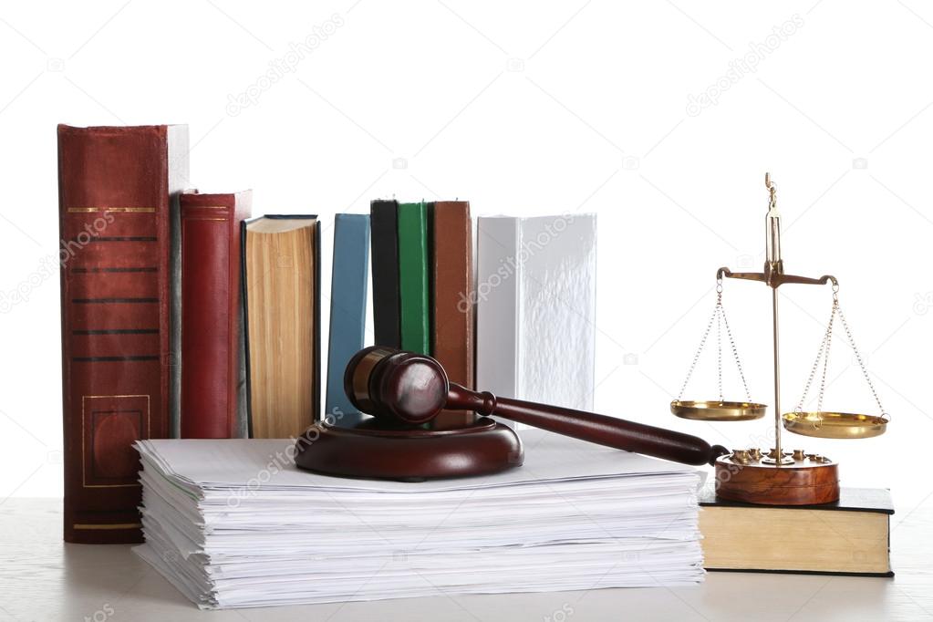 Wooden gavel with justice scales, stacks of documents and books on white background