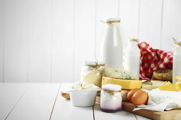 Set of fresh dairy products on white wooden table — Stock Photo, Image