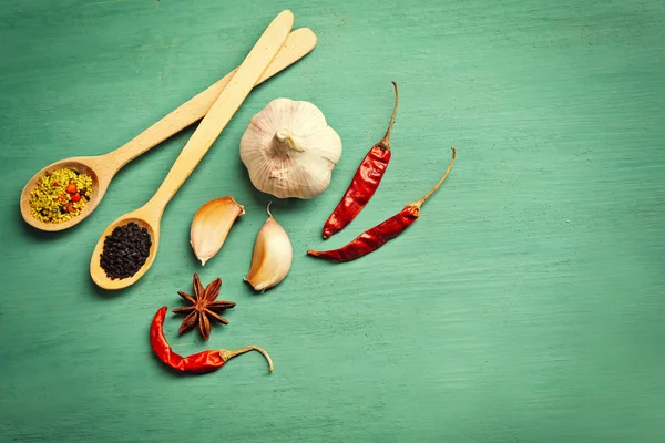 Assorted spices on wooden background — Stock Photo, Image