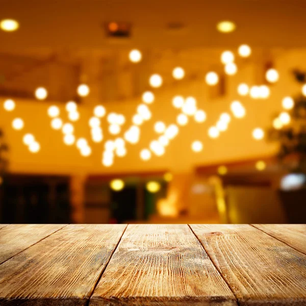 Empty wooden table and blurred interior — Stock Photo, Image