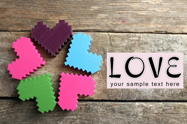 Plastic hearts on wooden background — Stock Photo, Image