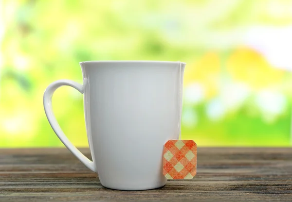 White cup with tea bag — Stock Photo, Image