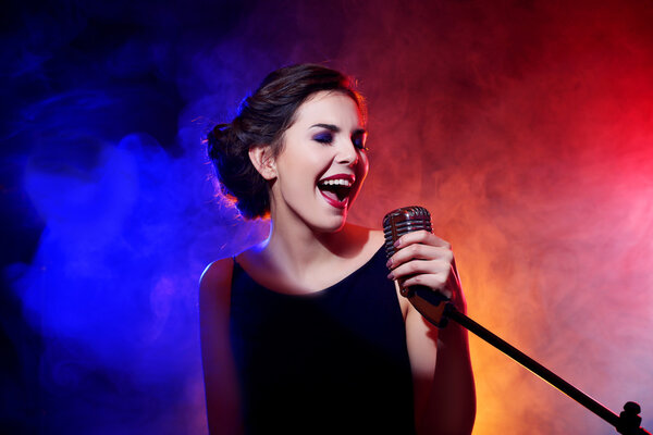 Young beautiful woman singing   