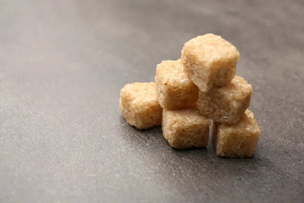 Pile of brown sugar cubes on the table — Stock Photo, Image