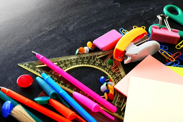 Colourful stationery on black — Stock Photo, Image