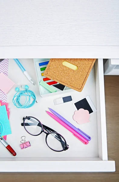 Stationery in open desk drawer