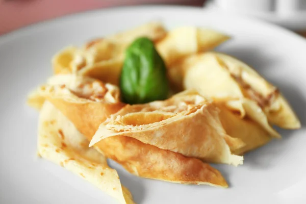 Tasty pancakes on plate in cafe, close up — Stock Photo, Image