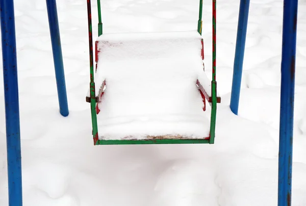 Swing covered with snow — Stock Photo, Image