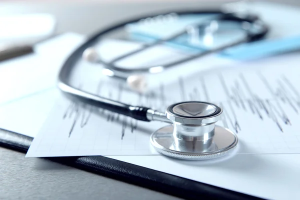 Cardiogram chart with medical stethoscope — Stock Photo, Image