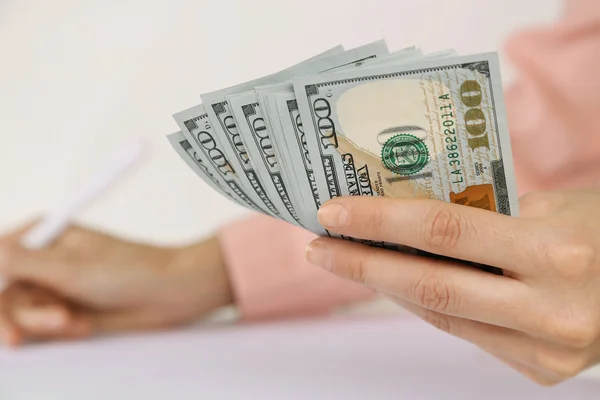 Hand holding dollar banknotes — Stock Photo, Image