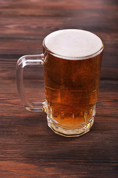 Glass of beer on wooden background — Stock Photo, Image