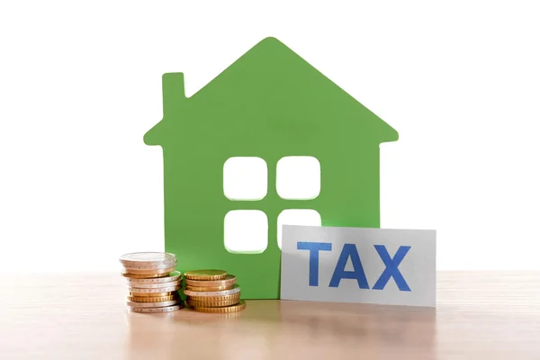 House figure, coins and tax sign — Stock Photo, Image