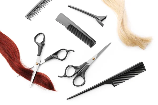 Scissors with combs, clip and strands of hair — Stock Photo, Image