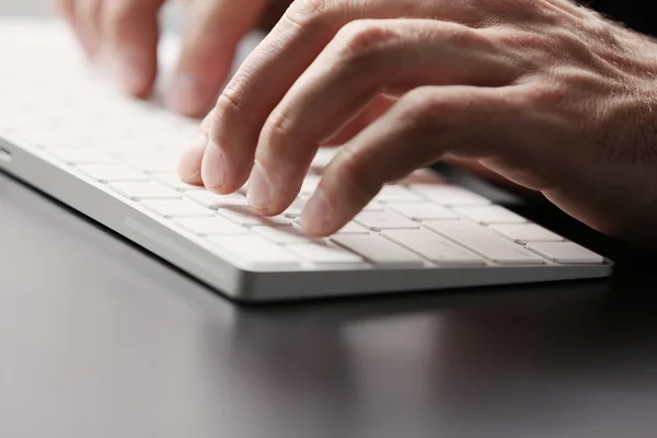 Male typing on wireless keyboard Royalty Free Stock Images