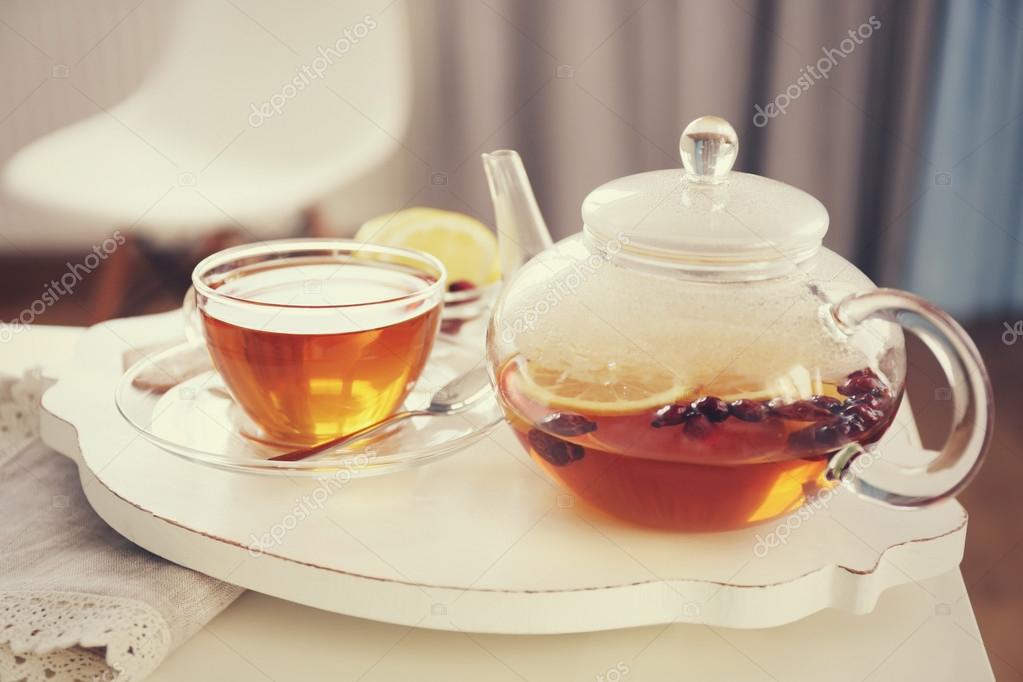 Tea set with hot tea and breakfast on a white wooden mat on the table Stock  Photo by ©belchonock 102145306
