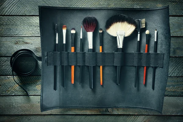 Makeup brushes in leather case — Stock Photo, Image