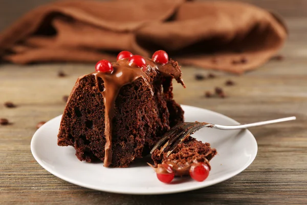 Piece of chocolate cake with snowball tree berries on a table — Stock Photo, Image