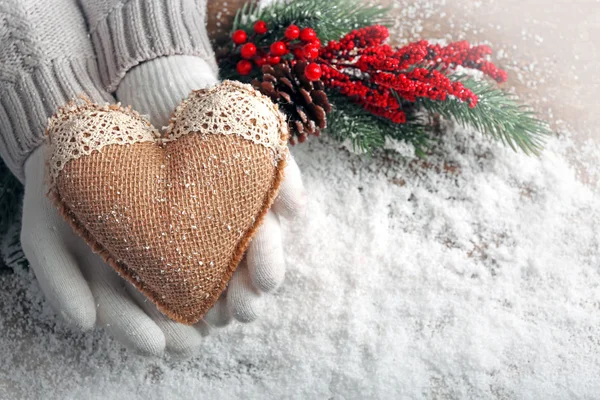 Hands in mittens with decorative heart — Stock Photo, Image