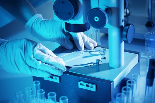 Scientist working with microscope — Stock Photo, Image