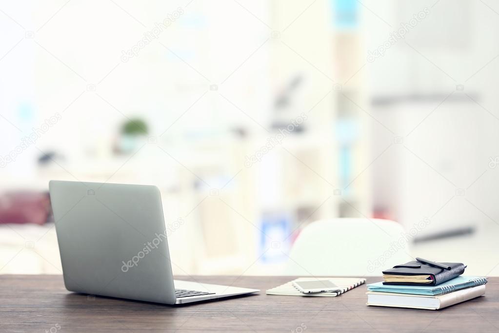 Workplace with laptop on table