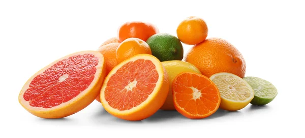 A heap of mixed citrus fruit sliced and unpeeled isolated on a white background, close up — Stock Photo, Image