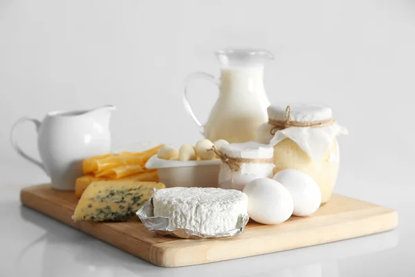 Set of fresh dairy products on wooden table, on white background — Stock Photo, Image