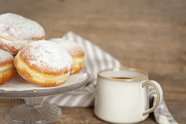 Delicious sugary donuts on wooden table closeup — Stock Photo, Image