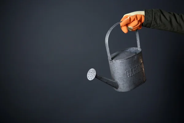 Hand holding metal watering can — Stock Photo, Image