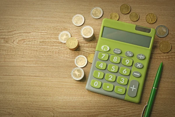 Money concept. Green calculator with coins — Stock Photo, Image