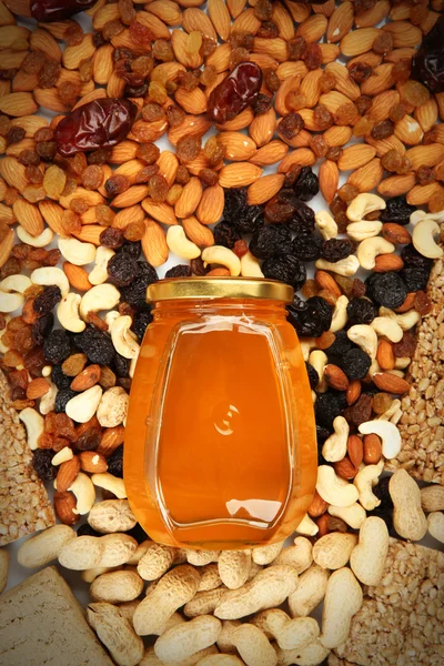Different kinds of nuts with honey, top view — Stock Photo, Image